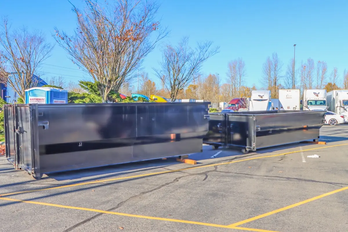 Professional dumpster rental service with roll-off container on residential driveway in Rancho Murieta